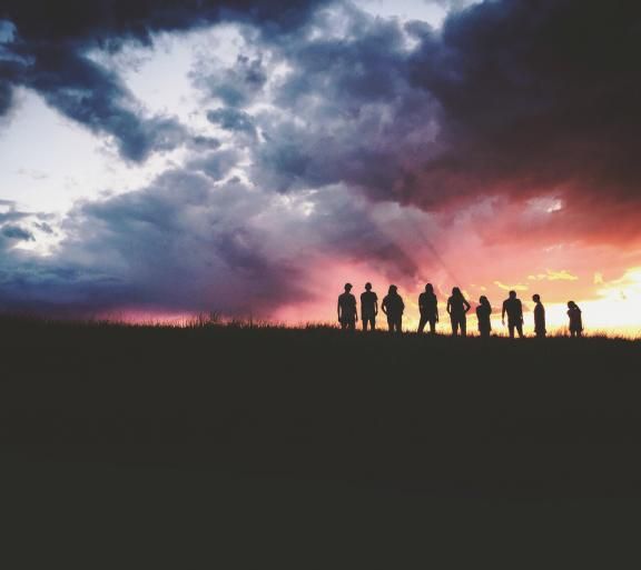 people standing on hilltop