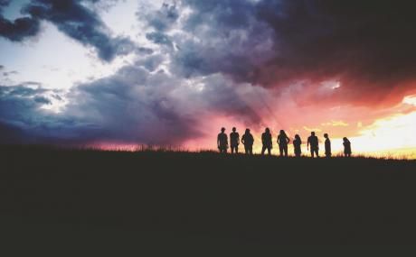 people standing on hilltop