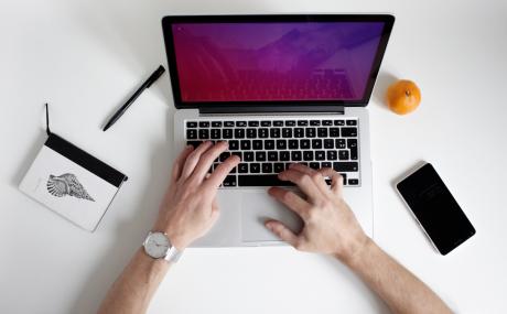 person typing on laptop