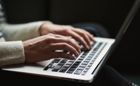 person typing on laptop