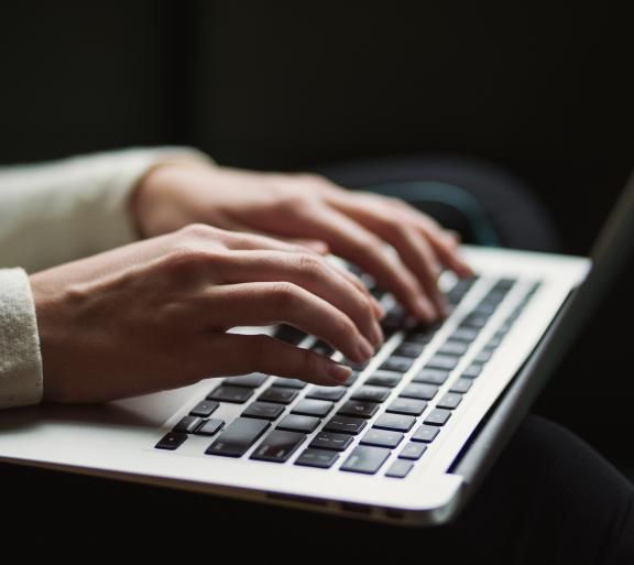 person typing on laptop