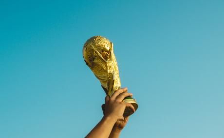 person holding gold figurine