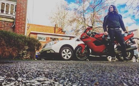 man standing in front of motorbike