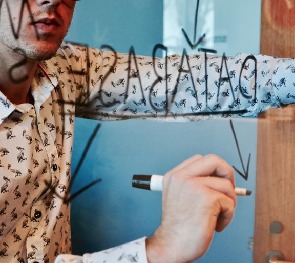 man writing on whiteboard