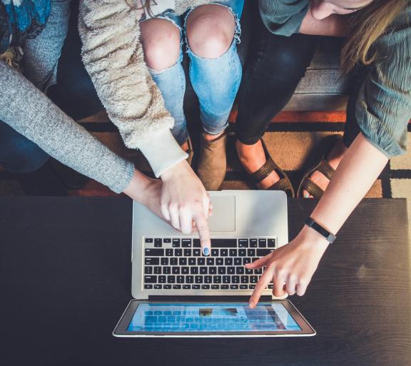 people collaborating with laptop