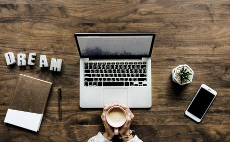 laptop on wood desk