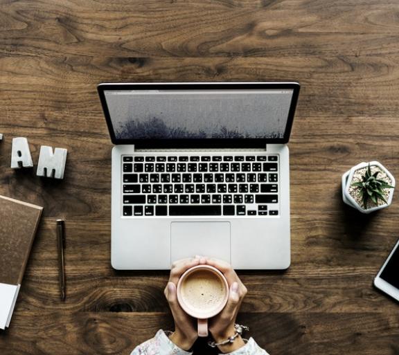 laptop on wood desk