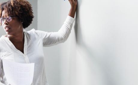 woman writing on whiteboard