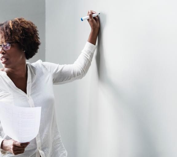 woman writing on whiteboard