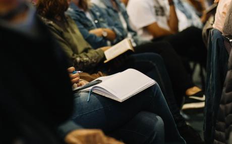 person sitting and taking notes