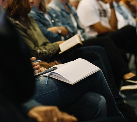 person sitting and taking notes