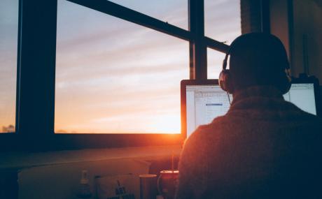 person in window at sunset