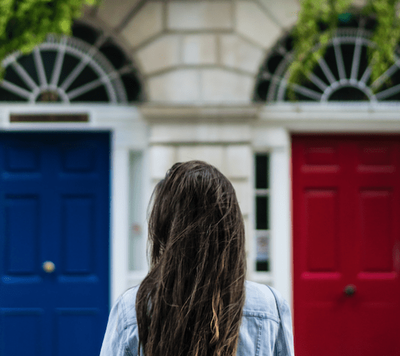 woman facing two doors